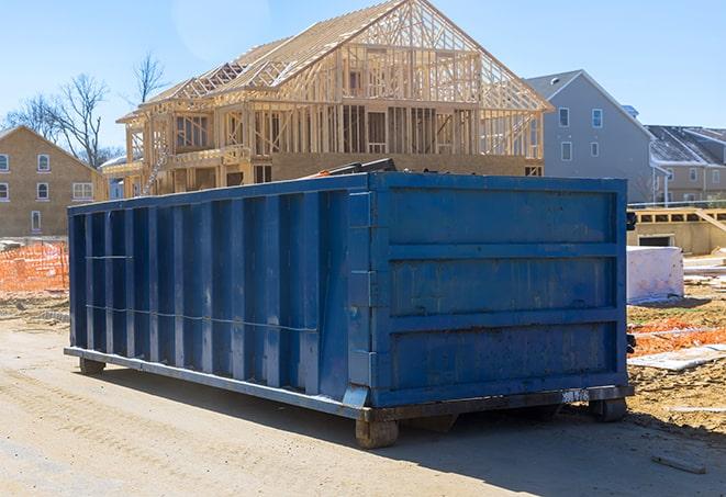 residential dumpsters parked in a neighborhood driveway